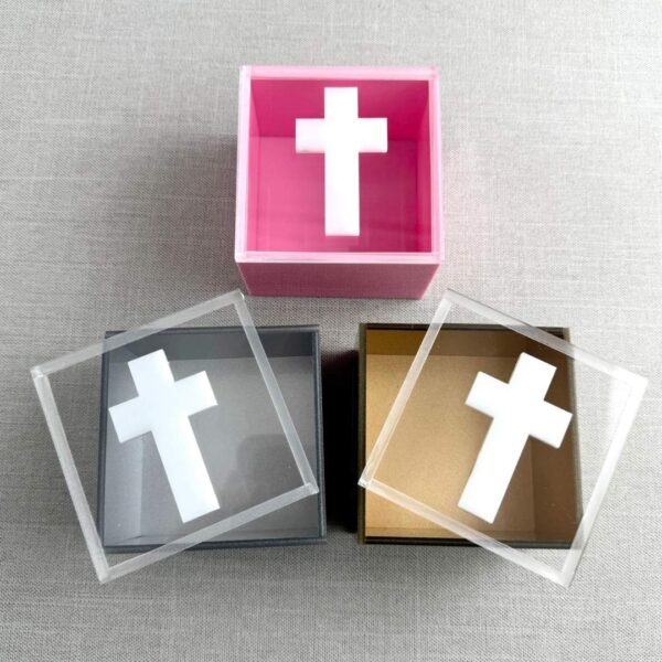 Cajas de acrílico con cruz blanca en la tapa, en colores rosa, negro y transparente , recuerdos elegantes y simbólicos de SSIENTO